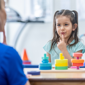 young girl practicing speech and language skills